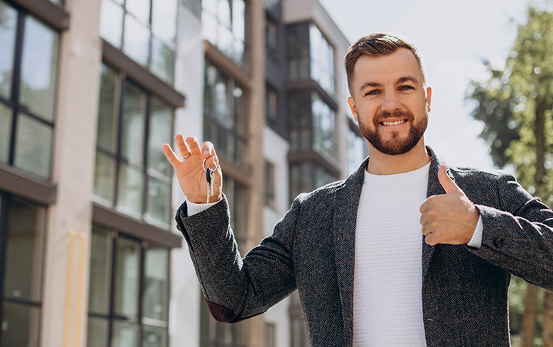 Young man with keys just bought new appartment
